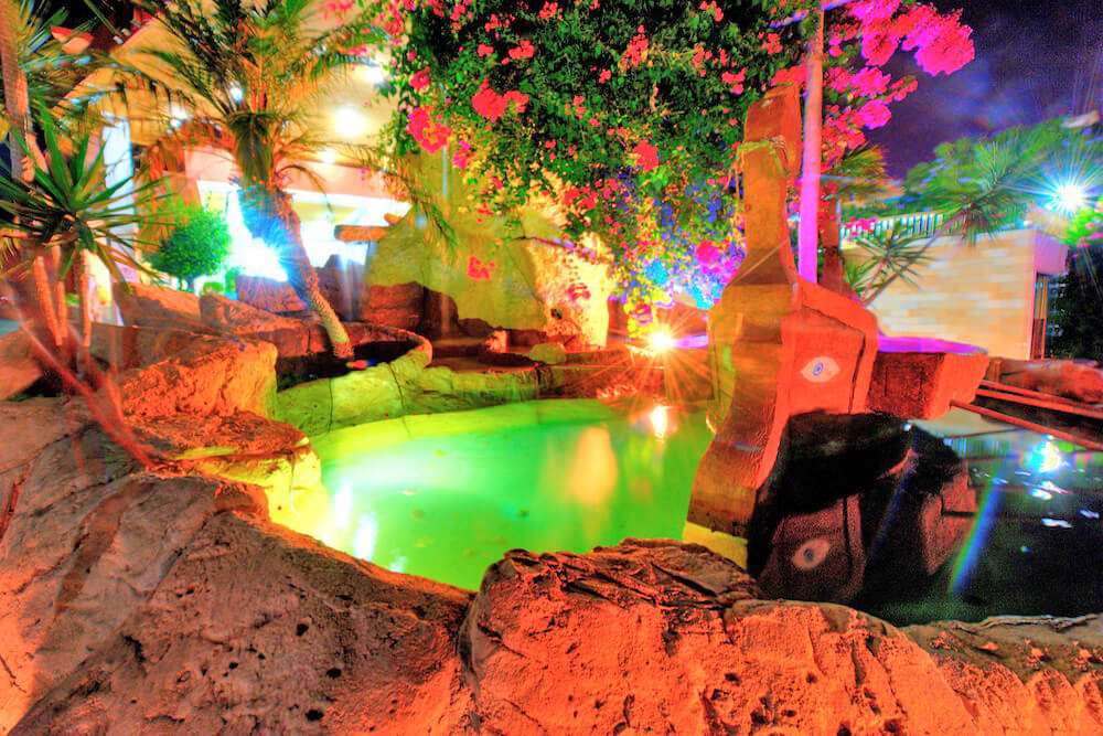 avlida hotel paphos pool by night